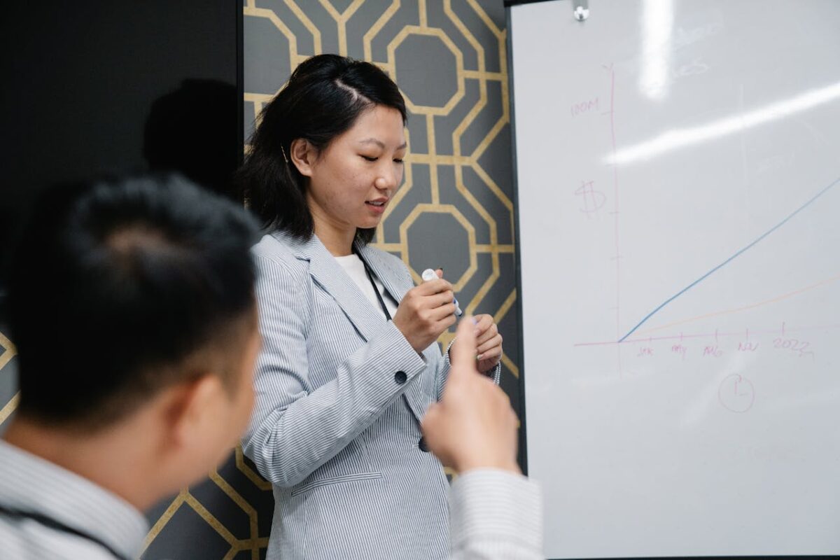 Business presentation with diverse professionals discussing growth chart in office.